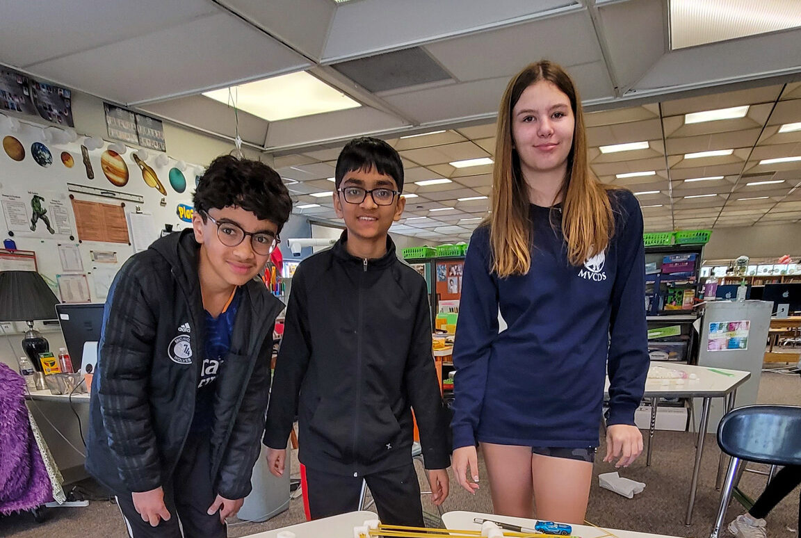 3 students smiling in classroom